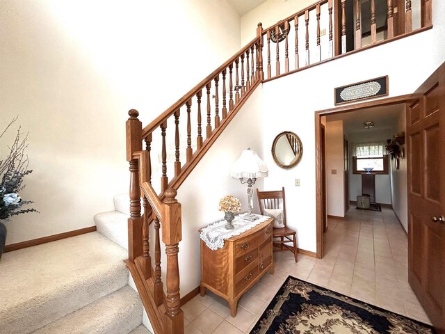 12541 Fleetwood Rd, Tomah, WI 54660 - stairs featuring a towering ceiling, baseboards, and tile patterned floors