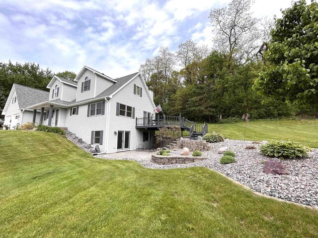12541 Fleetwood Rd, Tomah, WI 54660 - view of property exterior with stairs, a lawn, a wooden deck, and a patio