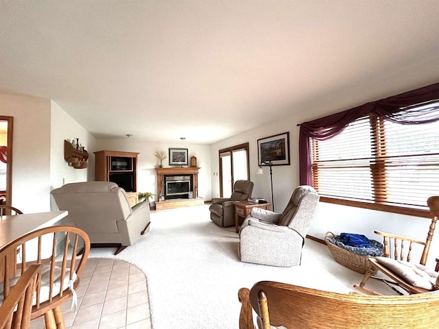 12541 Fleetwood Rd, Tomah, WI 54660 - living area with a glass covered fireplace, light colored carpet, and light tile patterned floors