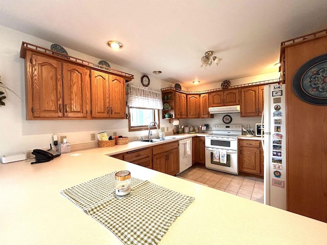 12541 Fleetwood Rd, Tomah, WI 54660 - kitchen featuring white appliances, a sink, light countertops, and brown cabinets