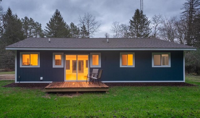 N3725 County Road Ee, Redgranite, WI 54970 - rear view of property featuring a yard, a wooden deck, and a shingled roof