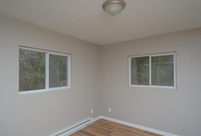 N3725 County Road Ee, Redgranite, WI 54970 - empty room featuring wood finished floors, baseboard heating, and baseboards