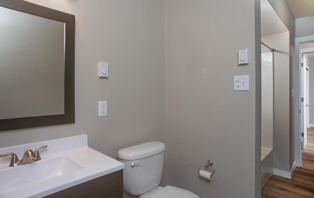 N3725 County Road Ee, Redgranite, WI 54970 - bathroom with wood finished floors, a shower, toilet, and vanity