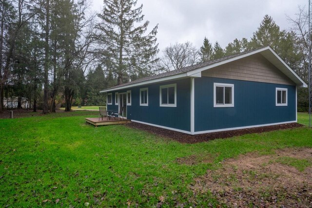 N3725 County Road Ee, Redgranite, WI 54970 - view of property exterior with a wooden deck and a lawn