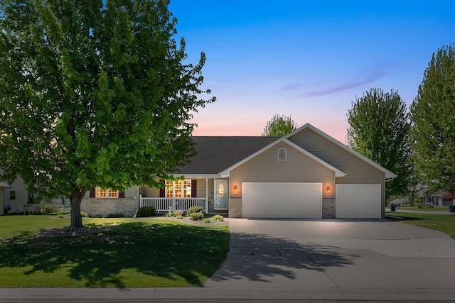 2891 Yellow Jasmine Way, Green Bay, WI 54313 - view of front of property with covered porch, concrete driveway, an attached garage, brick siding, and a yard