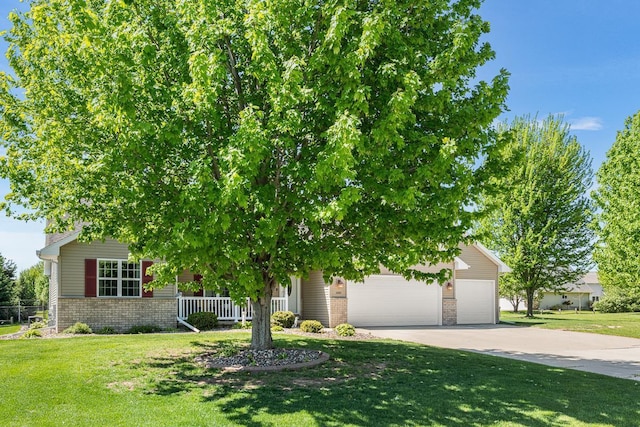 2891 Yellow Jasmine Way, Green Bay, WI 54313 - obstructed view of property featuring concrete driveway, brick siding, an attached garage, and a front lawn