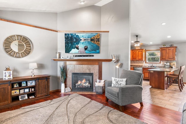 2891 Yellow Jasmine Way, Green Bay, WI 54313 - living area with high vaulted ceiling, a tile fireplace, a ceiling fan, light wood-style flooring, and recessed lighting
