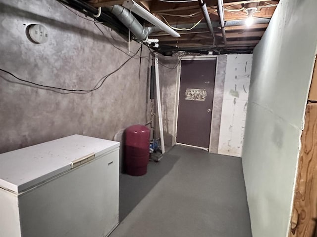6111 Magnolia Dr, Wisconsin Rapids, WI 54494 - unfinished basement with white fridge and a water pressure tank
