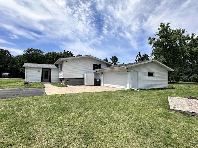 6111 Magnolia Dr, Wisconsin Rapids, WI 54494 - view of front of home with an outbuilding, a front lawn, an attached garage, and driveway