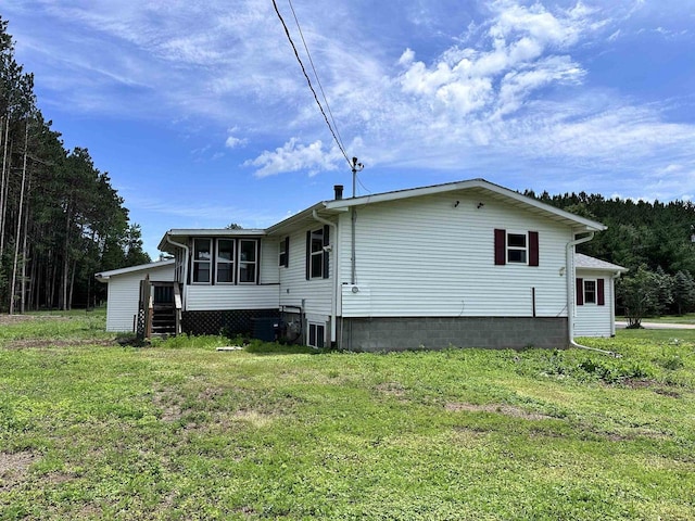 6111 Magnolia Dr, Wisconsin Rapids, WI 54494 - back of property with a sunroom and a lawn