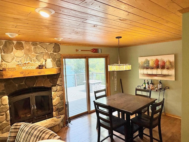 7002 Wildwood Ln, Rhinelander, WI 54501 - dining room featuring wooden ceiling, a stone fireplace, and light wood-style flooring