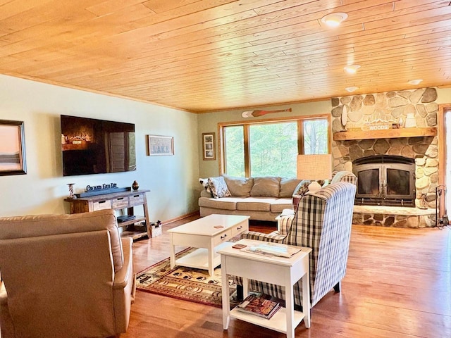 7002 Wildwood Ln, Rhinelander, WI 54501 - living area featuring wooden ceiling, wood finished floors, a fireplace, and crown molding