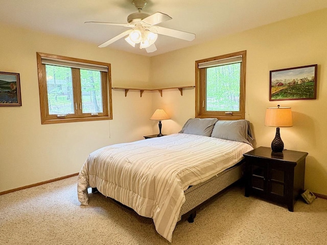 7002 Wildwood Ln, Rhinelander, WI 54501 - bedroom with light carpet, baseboards, and ceiling fan