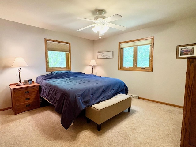 7002 Wildwood Ln, Rhinelander, WI 54501 - bedroom with multiple windows, light colored carpet, and baseboards