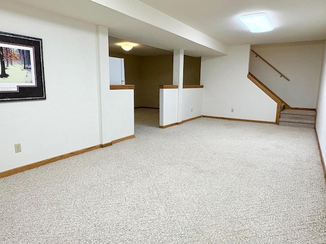 7002 Wildwood Ln, Rhinelander, WI 54501 - finished below grade area featuring light colored carpet, stairs, and baseboards