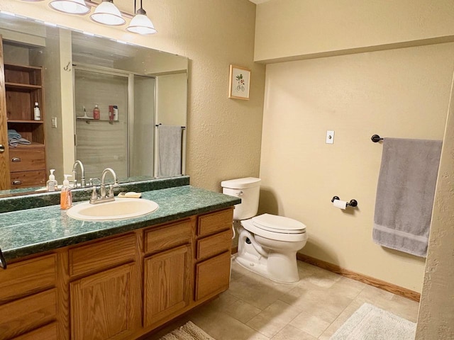 7002 Wildwood Ln, Rhinelander, WI 54501 - full bath with a shower stall, toilet, tile patterned floors, baseboards, and vanity