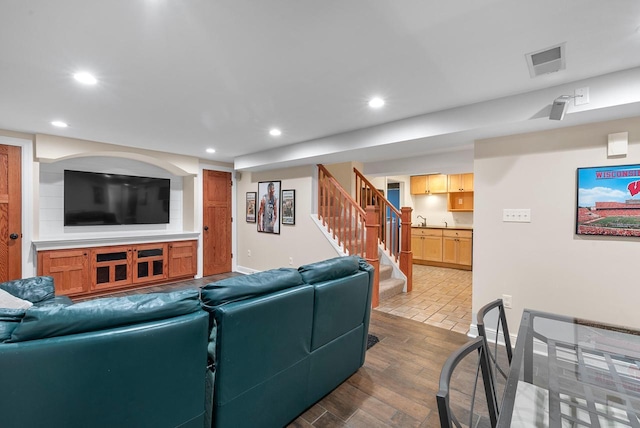 N51W15940 Fair Oak Pkwy, Menomonee Falls, WI 53051 - living area featuring wood finished floors, recessed lighting, stairway, and baseboards