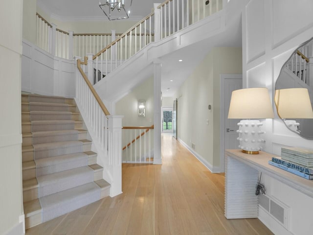 5021 Sherwood Ct, Burlington, WI 53105 - entrance foyer with wood-type flooring, baseboards, a high ceiling, and stairs