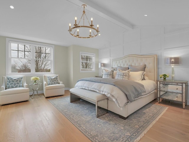 5021 Sherwood Ct, Burlington, WI 53105 - bedroom featuring a chandelier, wood finished floors, a decorative wall, and baseboards