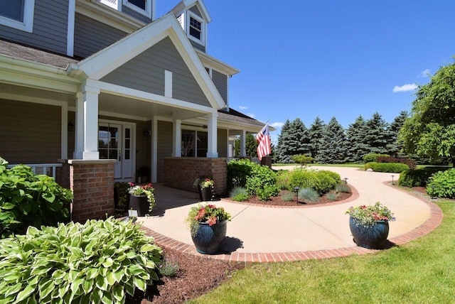 5021 Sherwood Ct, Burlington, WI 53105 - view of side of home featuring covered porch and brick siding