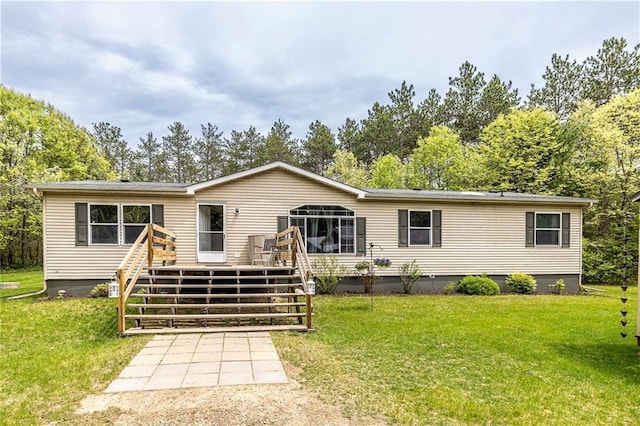 W14312 Montgomery Rd, Hixton, WI 54635 - rear view of property featuring a deck, a lawn, and crawl space