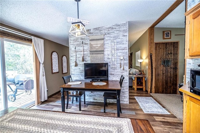 W14312 Montgomery Rd, Hixton, WI 54635 - dining space featuring wood finished floors, a textured ceiling, and a desk