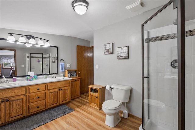 1941 Beulah Ave, East Troy, WI 53120 - bathroom featuring a stall shower, wood finished floors, toilet, and double vanity