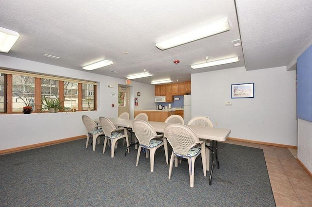 2142 Chateau Ct Unit 308-2, Grafton, WI 53024 - dining space featuring baseboards, a textured ceiling, and light tile patterned flooring