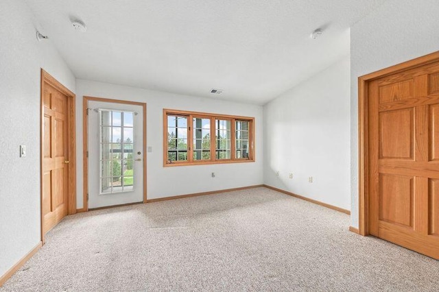 2142 Chateau Ct Unit 308-2, Grafton, WI 53024 - spare room featuring light colored carpet, healthy amount of natural light, and baseboards