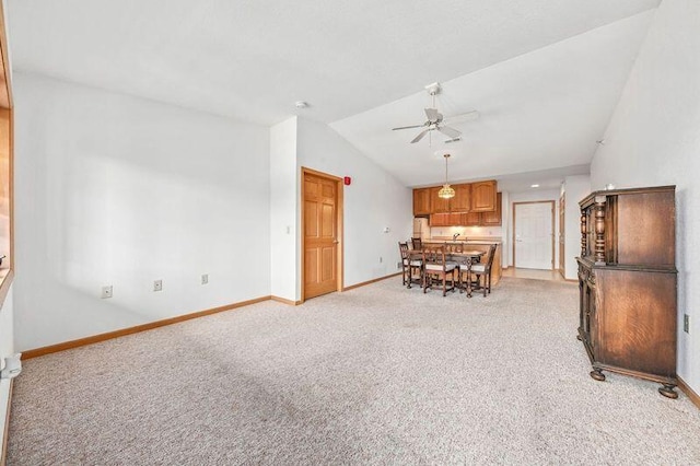 2142 Chateau Ct Unit 308-2, Grafton, WI 53024 - dining space with vaulted ceiling, light carpet, ceiling fan, and baseboards