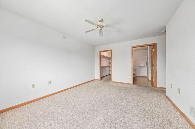 2142 Chateau Ct Unit 308-2, Grafton, WI 53024 - unfurnished bedroom with a spacious closet, baseboards, light colored carpet, a closet, and connected bathroom