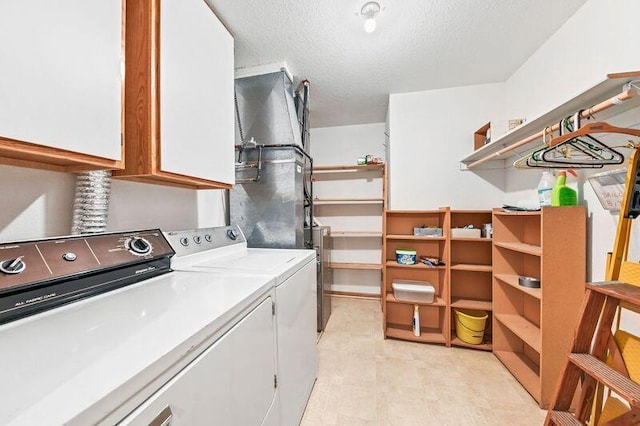 2142 Chateau Ct Unit 308-2, Grafton, WI 53024 - laundry area featuring cabinet space, independent washer and dryer, and a textured ceiling