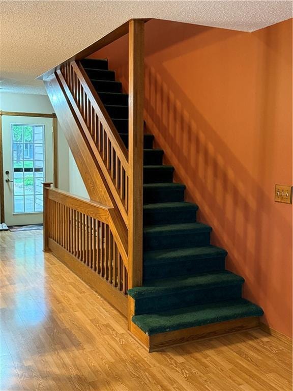 51 Stump Lake Rd, Chippewa Falls, WI 54729 - stairs featuring wood finished floors and a textured ceiling