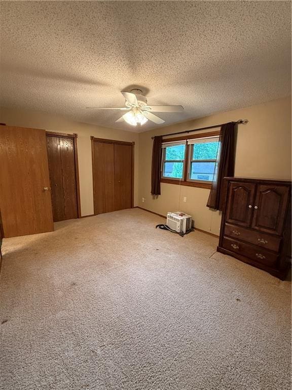51 Stump Lake Rd, Chippewa Falls, WI 54729 - unfurnished bedroom featuring a textured ceiling, multiple closets, light colored carpet, and ceiling fan