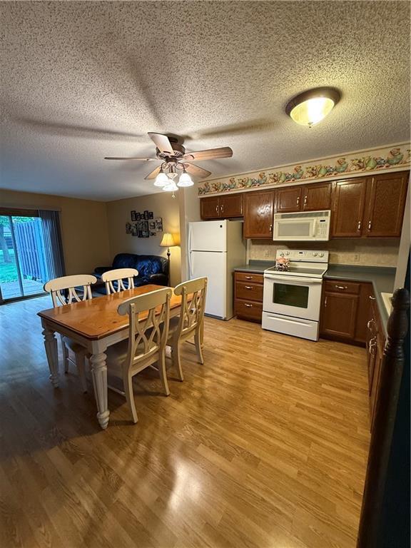 51 Stump Lake Rd, Chippewa Falls, WI 54729 - dining space featuring ceiling fan, light wood-style flooring, and a textured ceiling