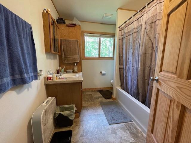 4546 Gold Leaf Ln, Ojibwa, WI 54862 - bathroom with toilet, vanity, and shower / bath combo with shower curtain