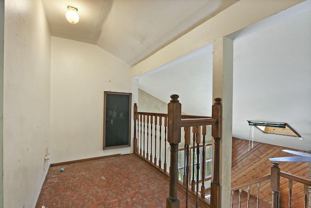 N7094 Evergreen Ln, Elkhorn, WI 53121 - corridor featuring an upstairs landing, lofted ceiling, baseboards, and brick patterned flooring