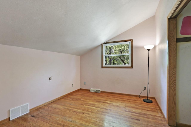 N7094 Evergreen Ln, Elkhorn, WI 53121 - bonus room with lofted ceiling, light wood-style floors, and baseboards