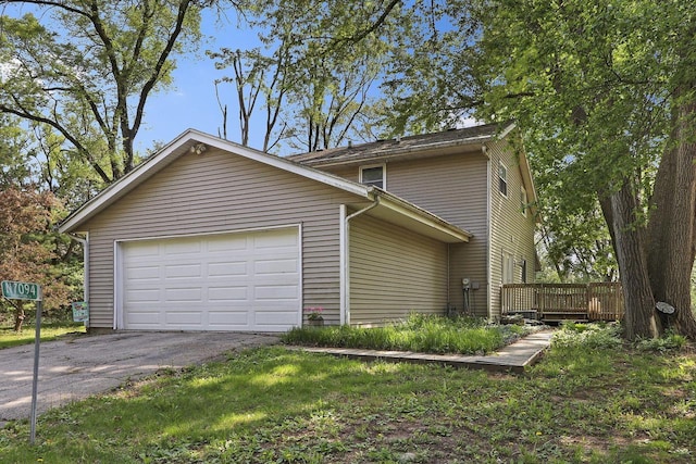 N7094 Evergreen Ln, Elkhorn, WI 53121 - view of side of home with asphalt driveway, a deck, and an attached garage