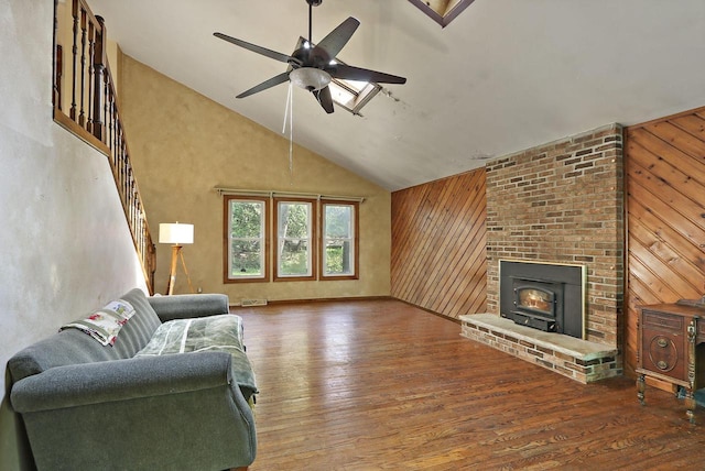 N7094 Evergreen Ln, Elkhorn, WI 53121 - living room featuring ceiling fan, hardwood / wood-style floors, wood walls, high vaulted ceiling, and stairs