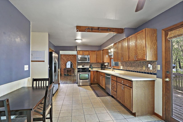 N7094 Evergreen Ln, Elkhorn, WI 53121 - kitchen featuring stainless steel appliances, a sink, tasteful backsplash, light countertops, and brown cabinetry