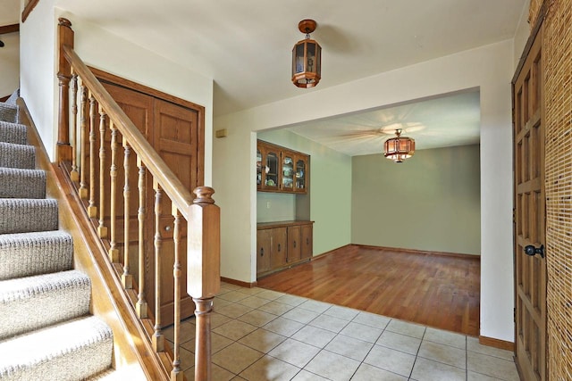 N7094 Evergreen Ln, Elkhorn, WI 53121 - foyer featuring light tile patterned floors, stairway, and baseboards