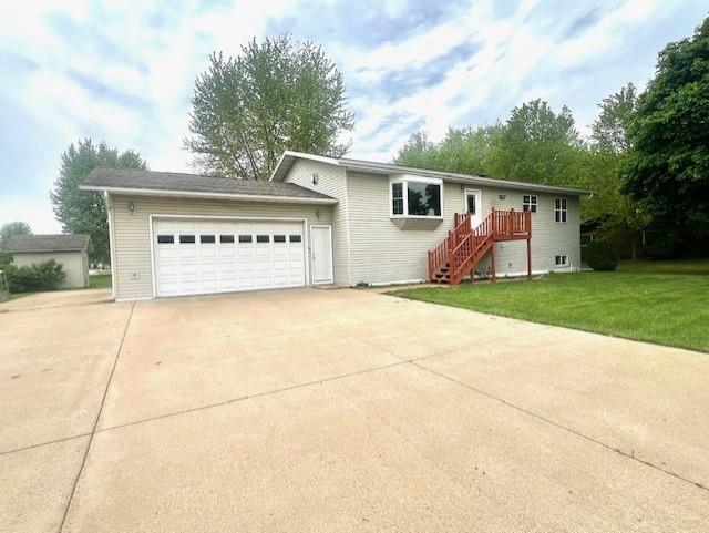 715 Farmer Ave, Tomah, WI 54660 - single story home featuring driveway, an attached garage, a front yard, and stairway