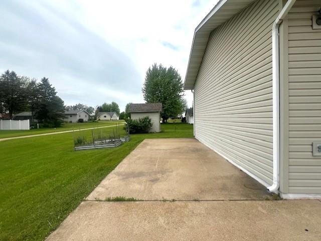 715 Farmer Ave, Tomah, WI 54660 - view of home's exterior featuring a lawn and a patio area