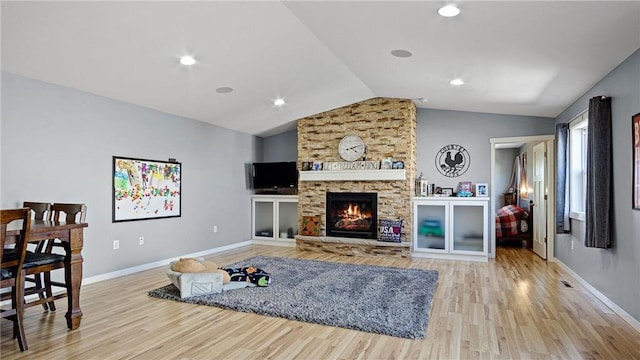 3312 White Oak Ln, Eau Claire, WI 54703 - living room with vaulted ceiling, wood finished floors, baseboards, and a fireplace