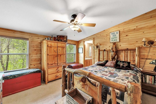 W6576 20th Dr, Wautoma, WI 54982 - bedroom featuring light colored carpet, wooden walls, vaulted ceiling, a textured ceiling, and a ceiling fan