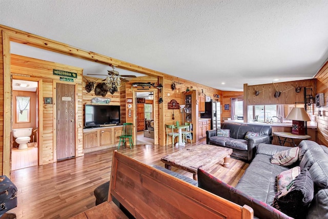 W6576 20th Dr, Wautoma, WI 54982 - living area with wood walls, wood finished floors, a textured ceiling, and ceiling fan