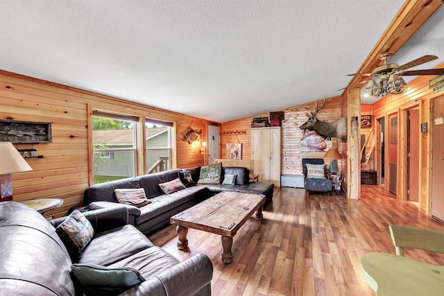 W6576 20th Dr, Wautoma, WI 54982 - living room featuring wooden walls, a textured ceiling, vaulted ceiling, hardwood / wood-style floors, and ceiling fan