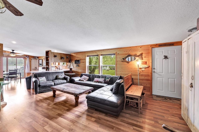 W6576 20th Dr, Wautoma, WI 54982 - living room with ceiling fan, plenty of natural light, a textured ceiling, wood finished floors, and wood walls