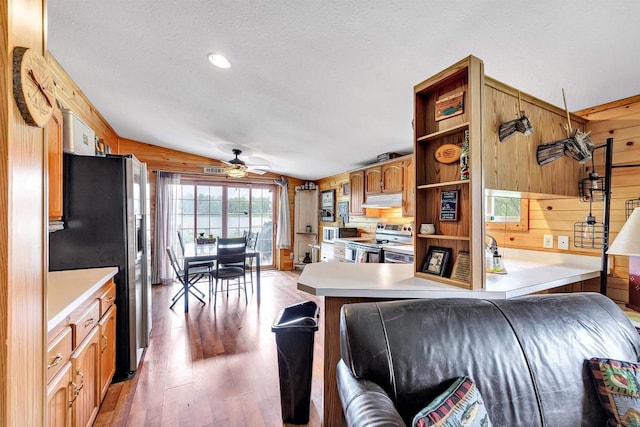 W6576 20th Dr, Wautoma, WI 54982 - living area with wood walls, ceiling fan, light wood-style flooring, a textured ceiling, and recessed lighting